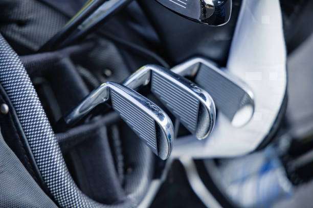 Golf clubs, including irons, neatly stored inside a modern golf bag.