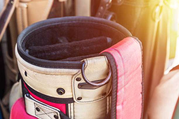 Close-up of the top opening of a vintage golf bag, showing club dividers inside.